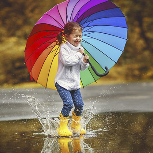 High-resolution photo of a girl with a rainbow umbrella, which will print nicely.