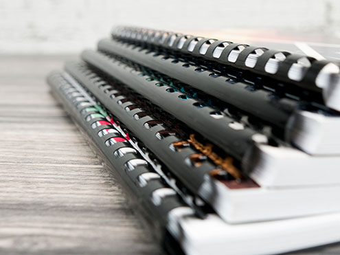 Comb bound books with flexible plastic spine combs